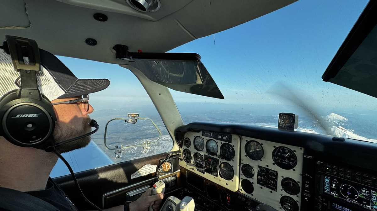 heli pilot in sky for a blog about part 61 vs. 141