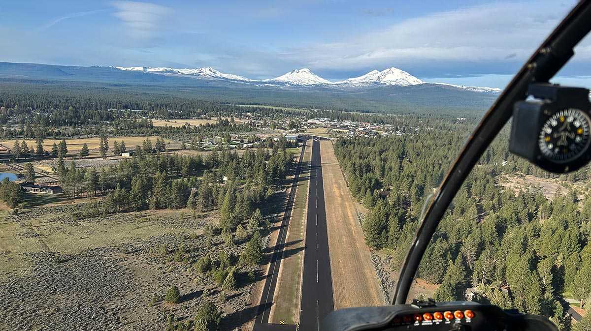 ariel view of heli flying above mountains for blog about flight operations