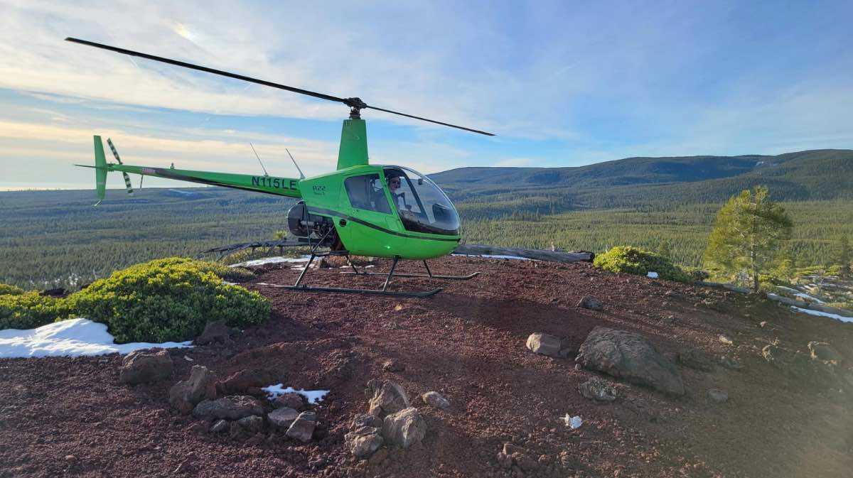 helicopter landing in field for a blog promoting instructor pilot course