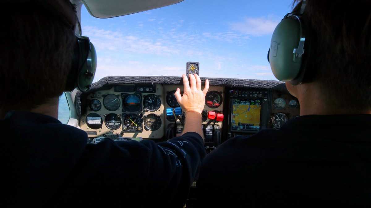 Two people piloting a flying helicopter for a blog about vfr lost procedures