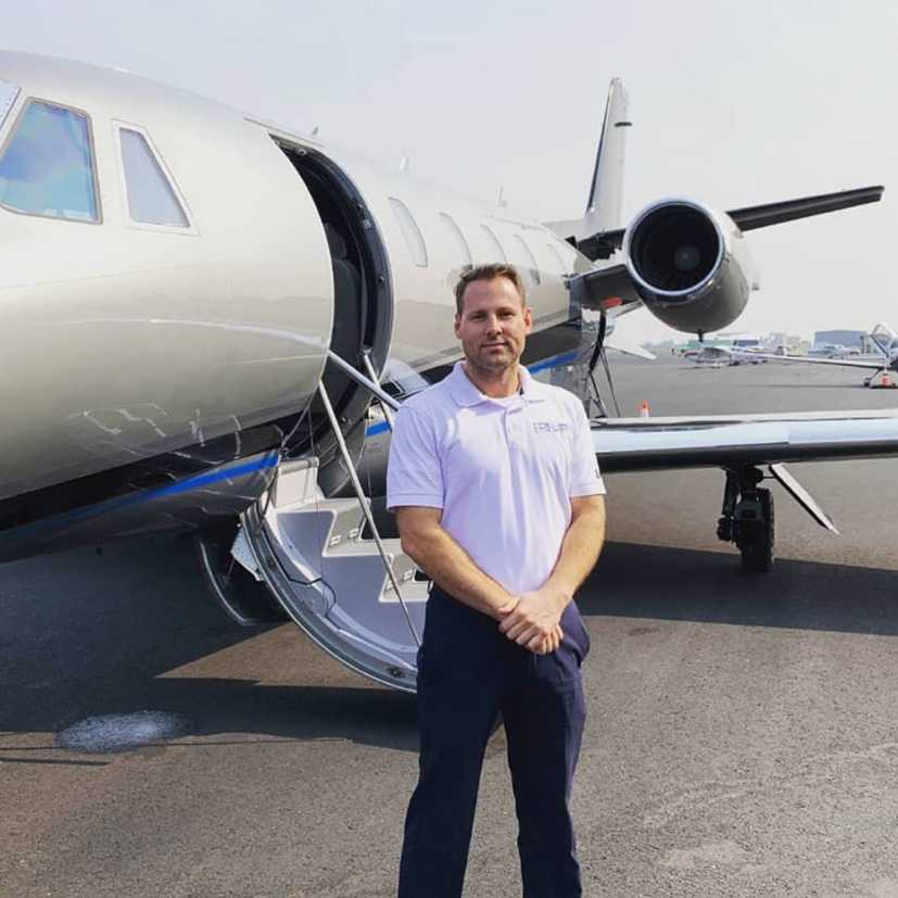 aviation degree program student standing in front of an airplane